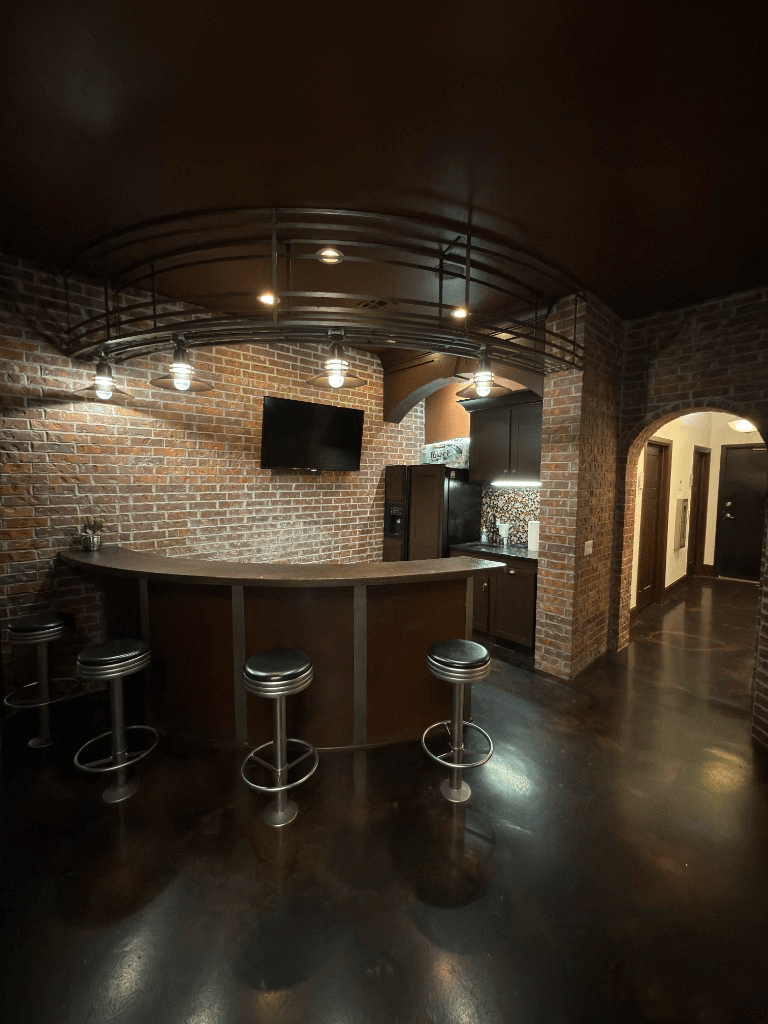 Brick-walled lounge with bar seating at Oak & Sage Wellness Center in Edmond