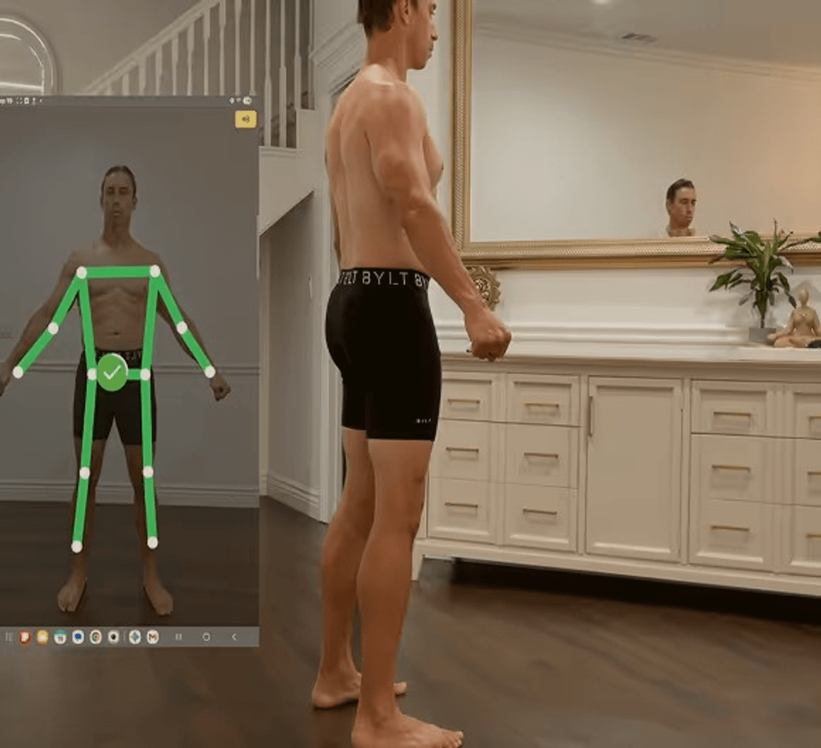 Person completing a SNAP by Fit3D body scan with the measurement app overlay visible